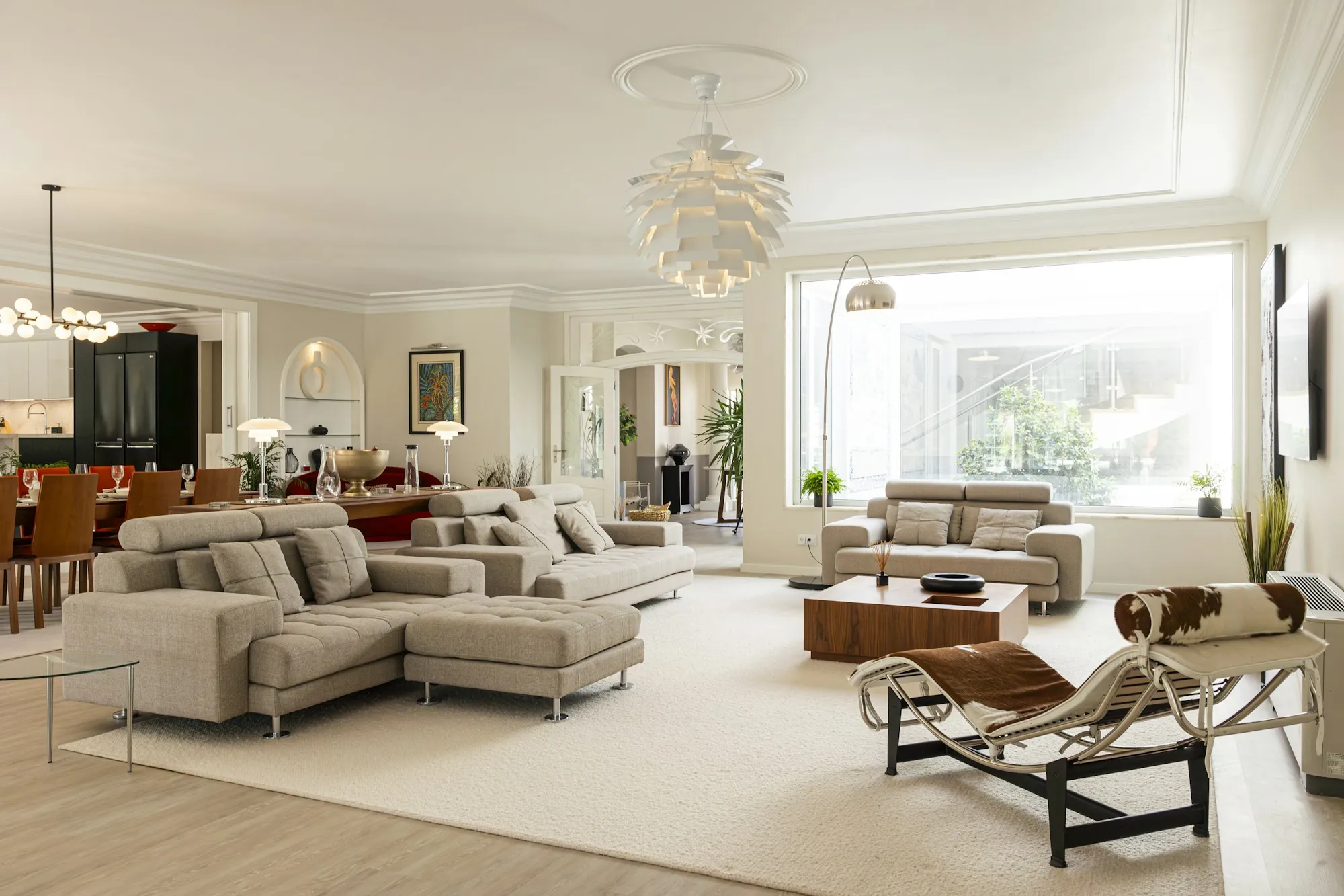 Open living room with sectional sofa and a view to the dining area
