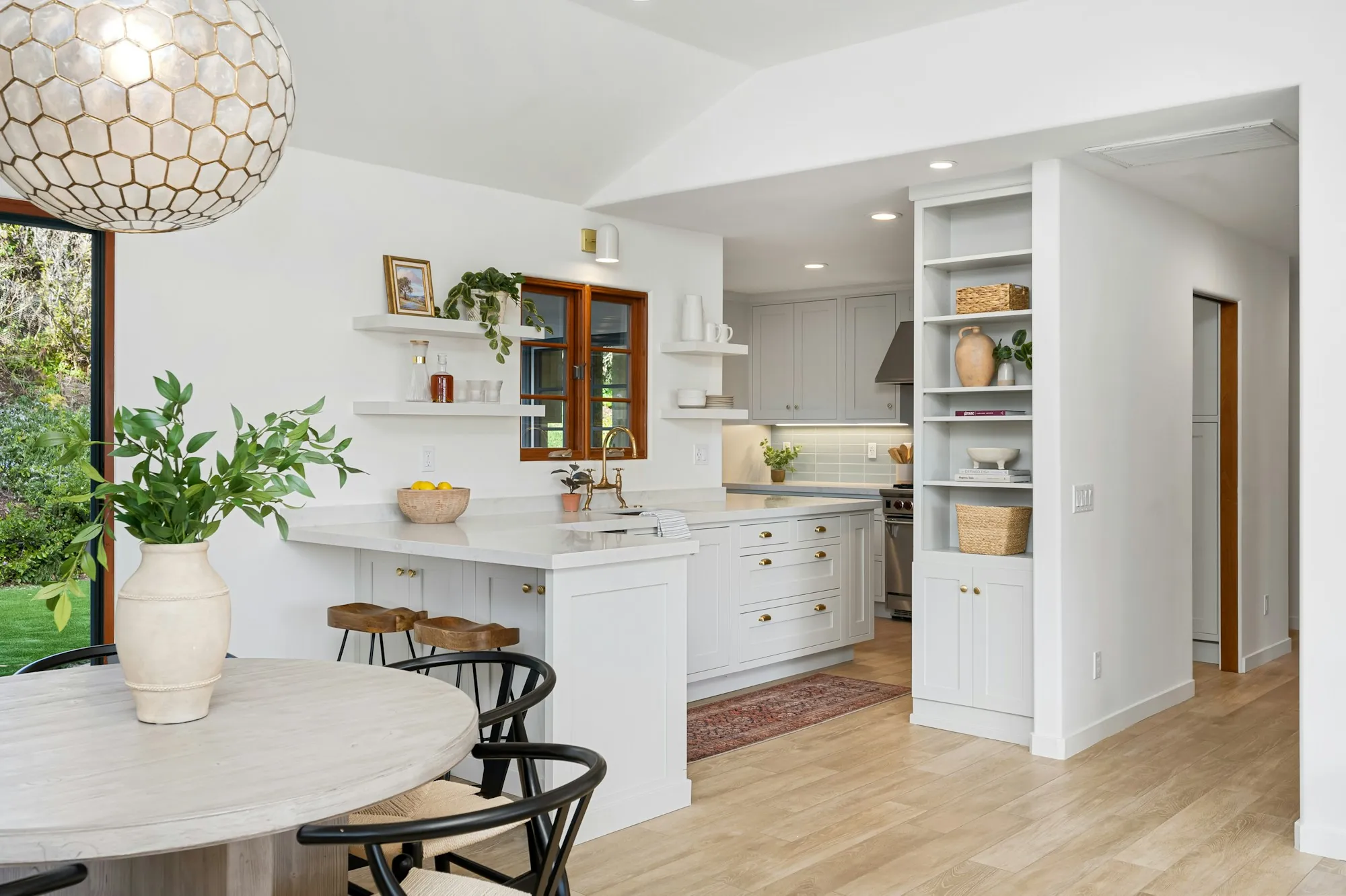 White kitchen with open shelves and a breakfast nook